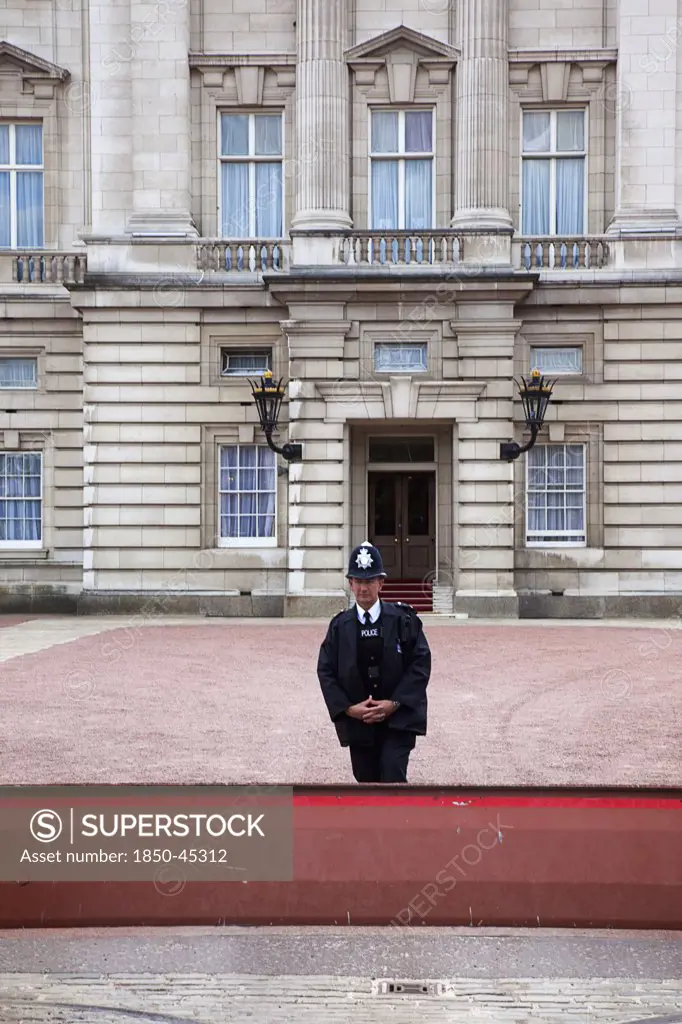 Westminster Buckingham Palace exterior with Police guard at the entrance.England London