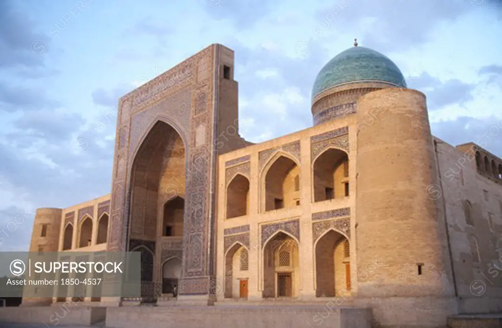 Uzbekistan, Bhukhara, Mir I Arab Madrassah Mosque Facade And Dome Seen In Evening Light