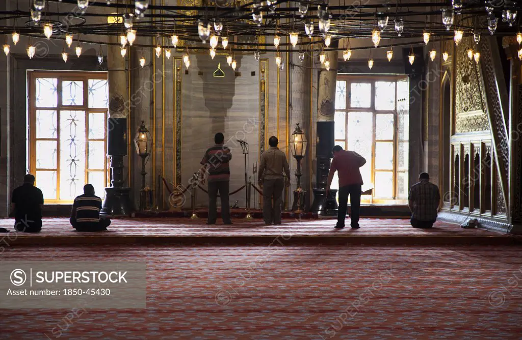 Sultanahmet Camii Blue Mosque interior with men at worship. , Turkey Istanbul