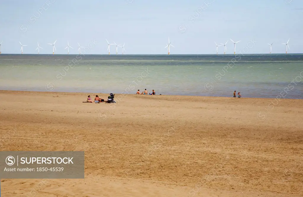 England, Lincolnshire, Skegness, Lincs Wind Farm  offshore on the horizon showing turbine blades.