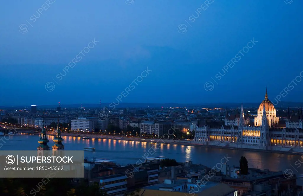 Hungary, Budapest, Buda Castle District, view over Danube and Pest with Parliament Building illuminated.