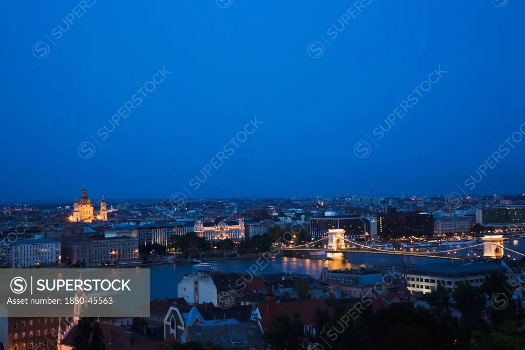 Hungary, Budapest, Buda Castle District, view over Danube and Pest with St Stephen's Basilica illuminated.