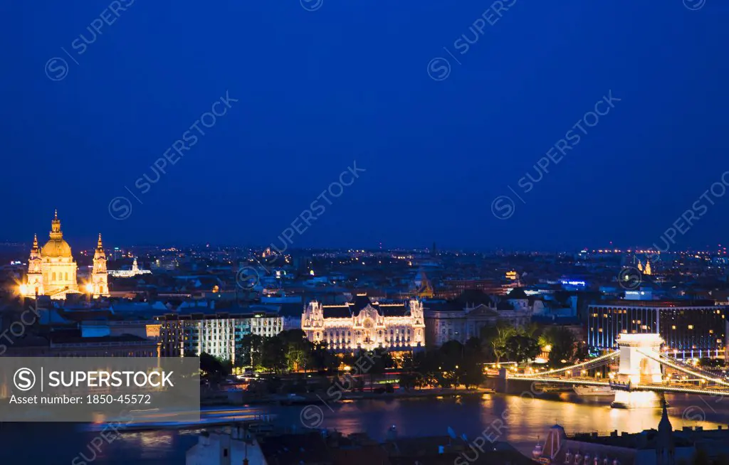 Hungary, Budapest, Buda Castle District, view over Danube and Pest with St Stephen's Basilica illuminated.
