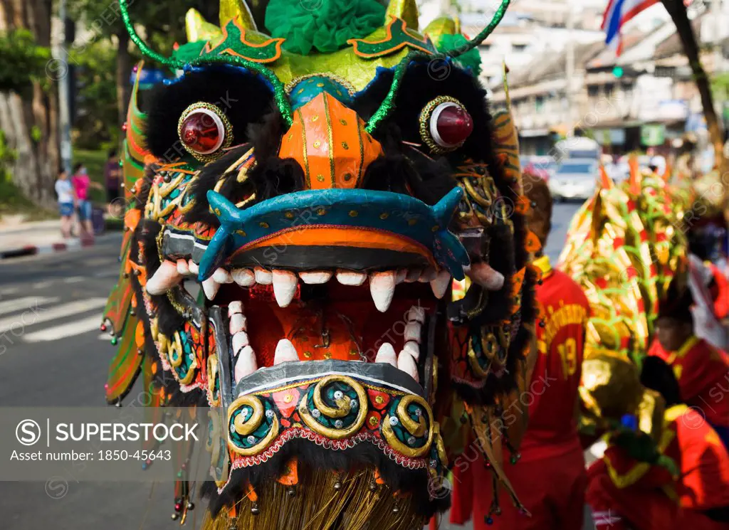 Thailand, Bangkok, Dragon Dance head carried in parade celebrating local temple on New Road , first paved road in the city.