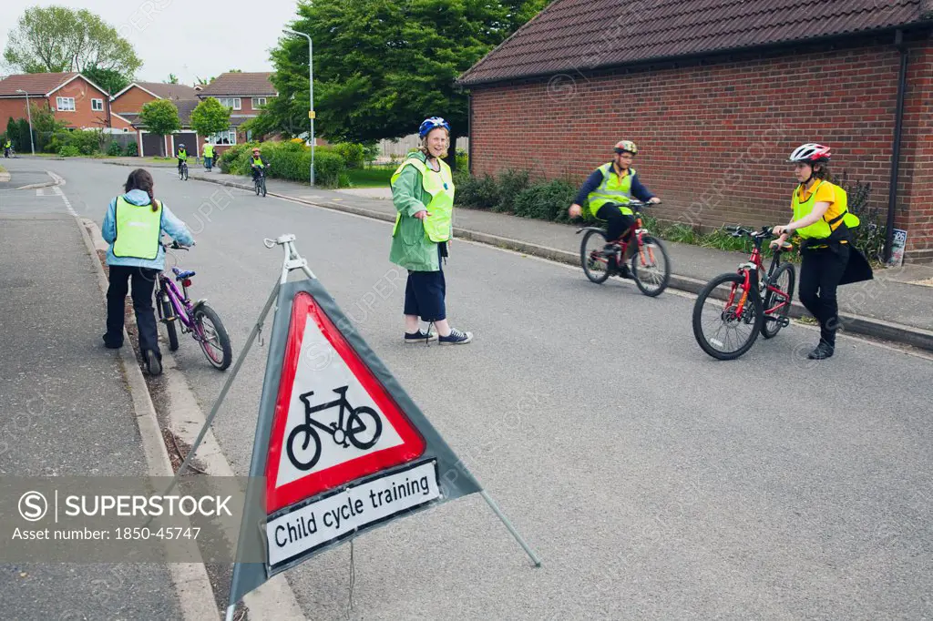 England, Lincolnshire, School children being taught cycle safety lessons on public roads.