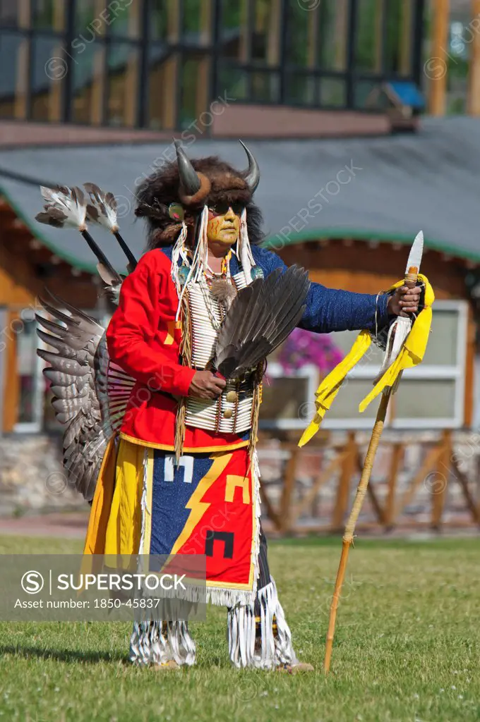 Canada, Alberta, Waterton Lakes National Park, Blackfoot dancer in a buffalo headdress at the Blackfoot Arts & Heritage Festival Pow Wow organized by Parks Canada and the Blackfoot Canadian Cultural Society.