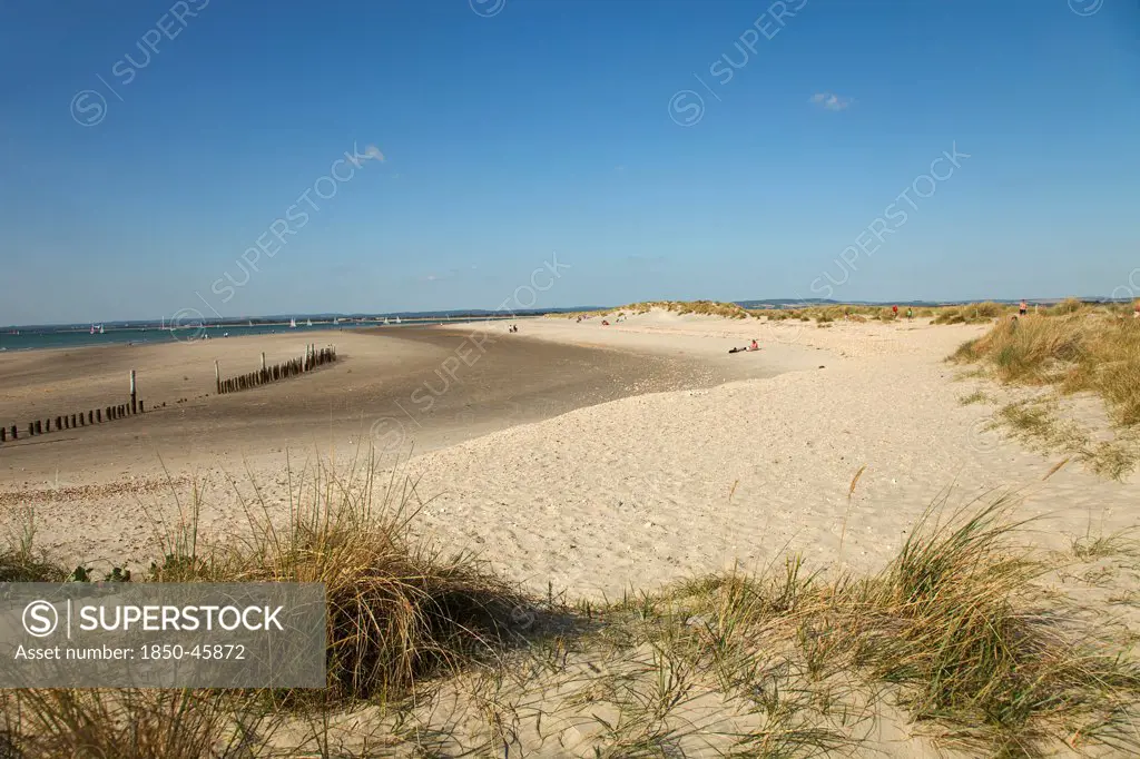 England, West Sussex, West Wittering Beach, View across sand dunes towards beach and sea at East Head. Sunshine and blue sky.