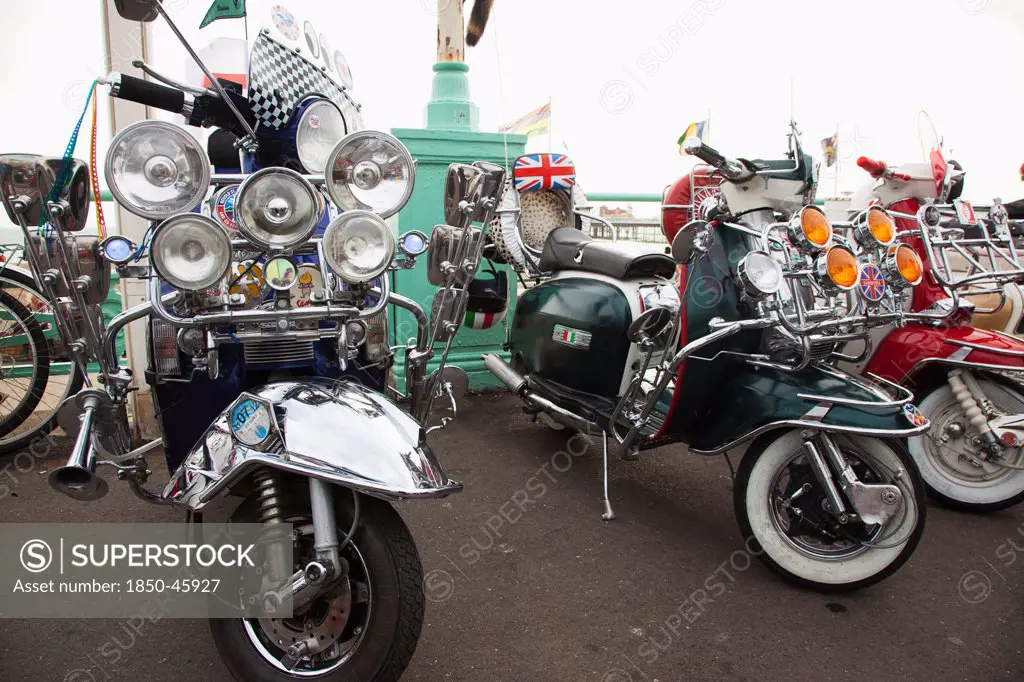 England, East Sussex, Brighton, Elaborately decorated Mopeds on Madeira Drive during motorbike festival.