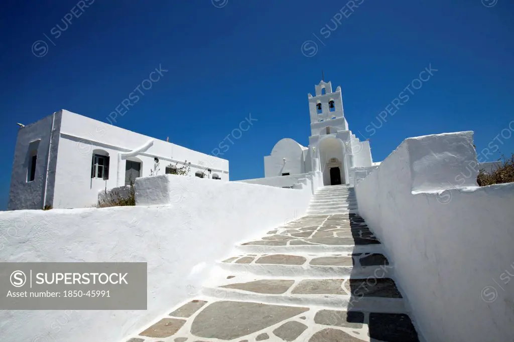 Greece, Cyclades Island, Sifnos Island, Landscape format low angle photograph of the church inside Chrissopigi monastery which is build on the top of a cliff nearby Platis Yalos village and it is famous for housing the miraculous icon of Panagia Chrissopigi.