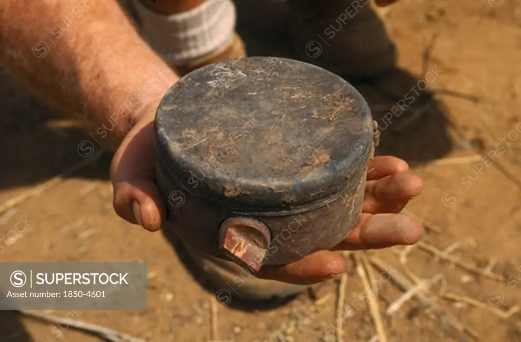 Mozambique , Dombe, Man Holding Russian Made Anti Personnel Mine.