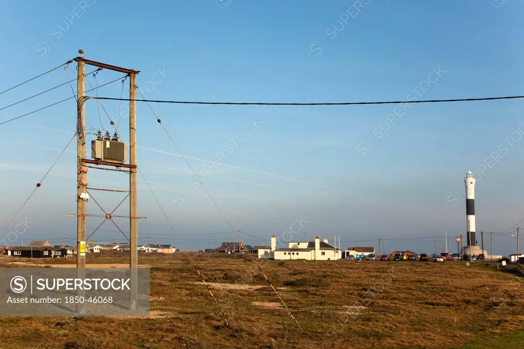 England, Kent, Romney Marsh, Dungeness, View toward the Light Railway Cafe with power cables in the foreground.