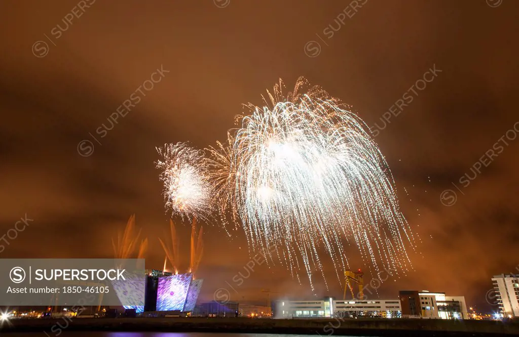 Ireland, North, Belfast, Titanic Quarter, Visitor centre designed by Civic Arts & Eric R Kuhne, illuminated during opening fireworks and projection display.