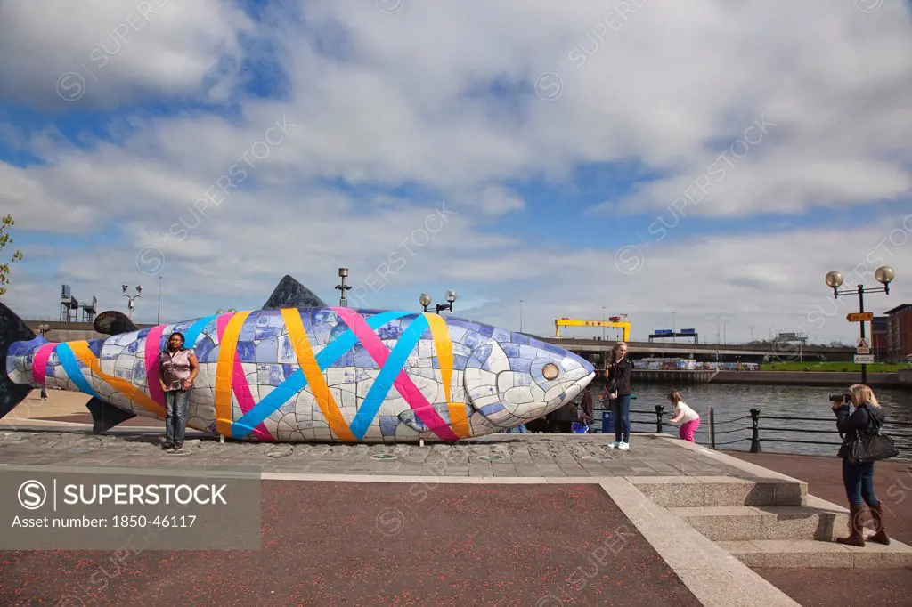 Ireland, North, Belfast, Donegall Quay The Big Fish Sculpture by John Kindness. The scales of the fish are pieces of printed blue tiles with details of Belfasts history. The 10 metre long structure is situated beside the Lagan Weir opposite the old Custom House.