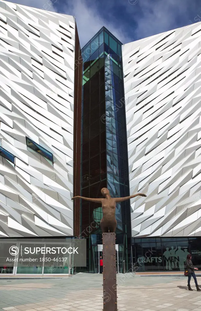 Ireland, North, Belfast, Titanic Quarter, Visitor centre designed by Civic Arts & Eric R Kuhne, with statue of diving woman in foreground.