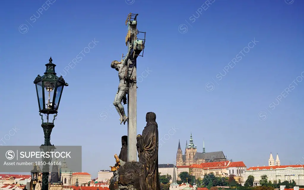 Czech Republic, Bohemia, Prague, Charles Bridge, Calvary with St Vitus in the background.