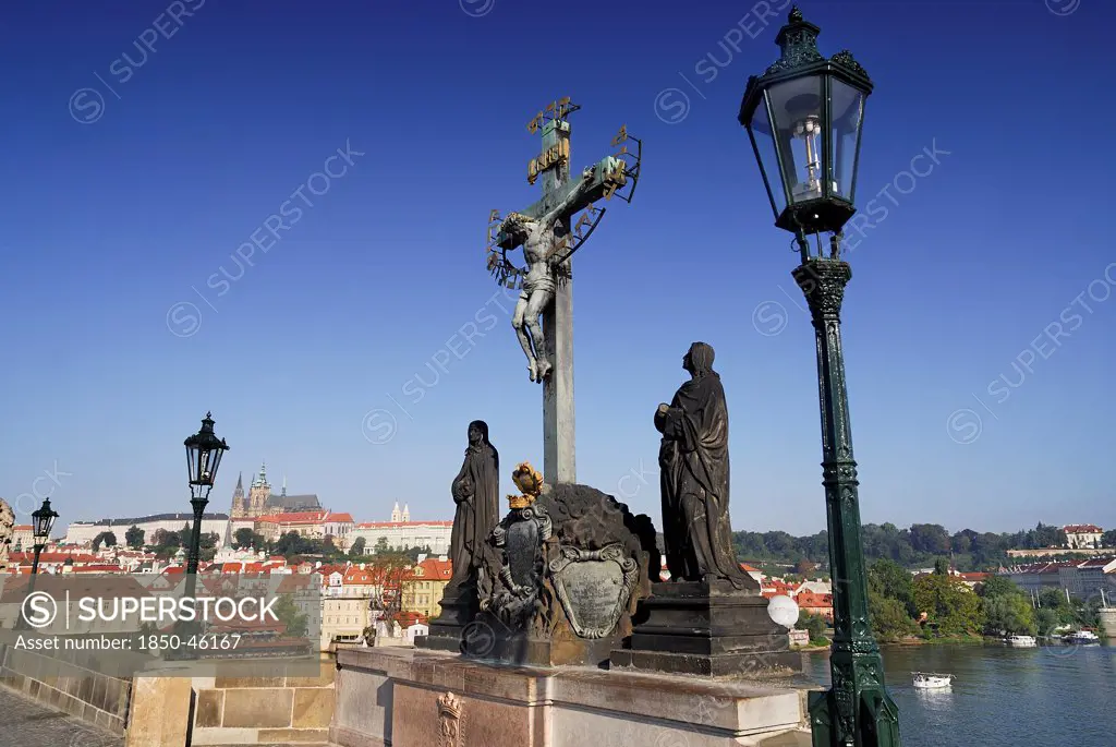 Czech Republic, Bohemia, Prague, Charles Bridge, Calvary with St Vitus in the background.