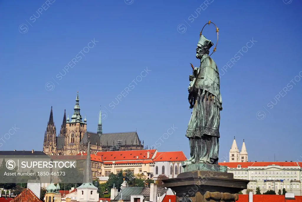 Czech Republic, Bohemia, Prague, Charles Bridge, Statue of St John of Nepomuk with St Vitus.
