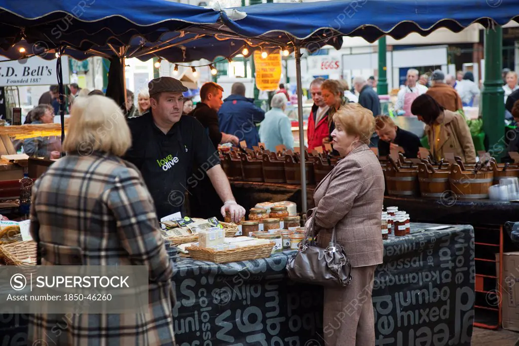 Ireland, North, Belfast, St Georges Market, stall selling, olives, cheese and preserves.