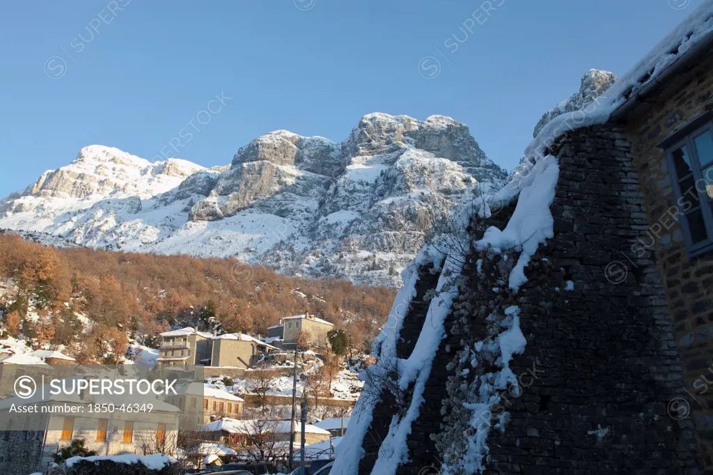 Greece, MAcedonia, Zagorohoria, View of the small traditional Greek village Mikro Papigko or Little Papigko built underneath the  mountain.