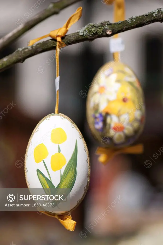 Austria, Vienna, Hand-painted egg shells hanging from a branch to celebrate Easter at the Old Vienna Easter Market at the Freyung.