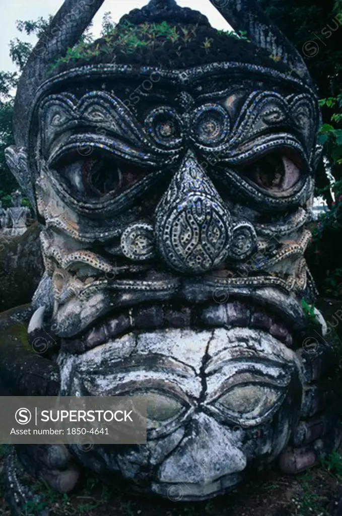 Laos, Vientiane , Buddha Park.  Detail Of Fierce Stone Sculpture Face.