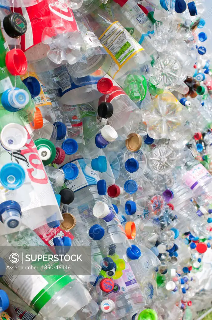 Environment, Recycling, Plastic bottles attached to a wire fence at the WOMAD festival, to highlight the need to recycle non-sustaninable materials.