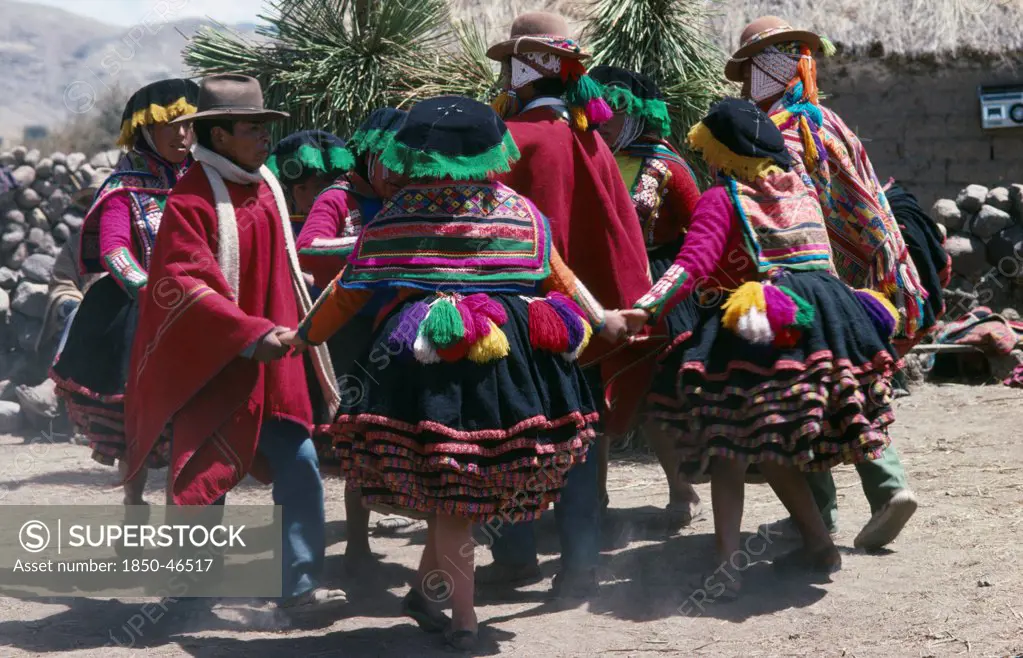 Peru, Cusco, Vilcanota Mountains, Tinqui. Villagers in traditional costume dancing during wedding celebrations.