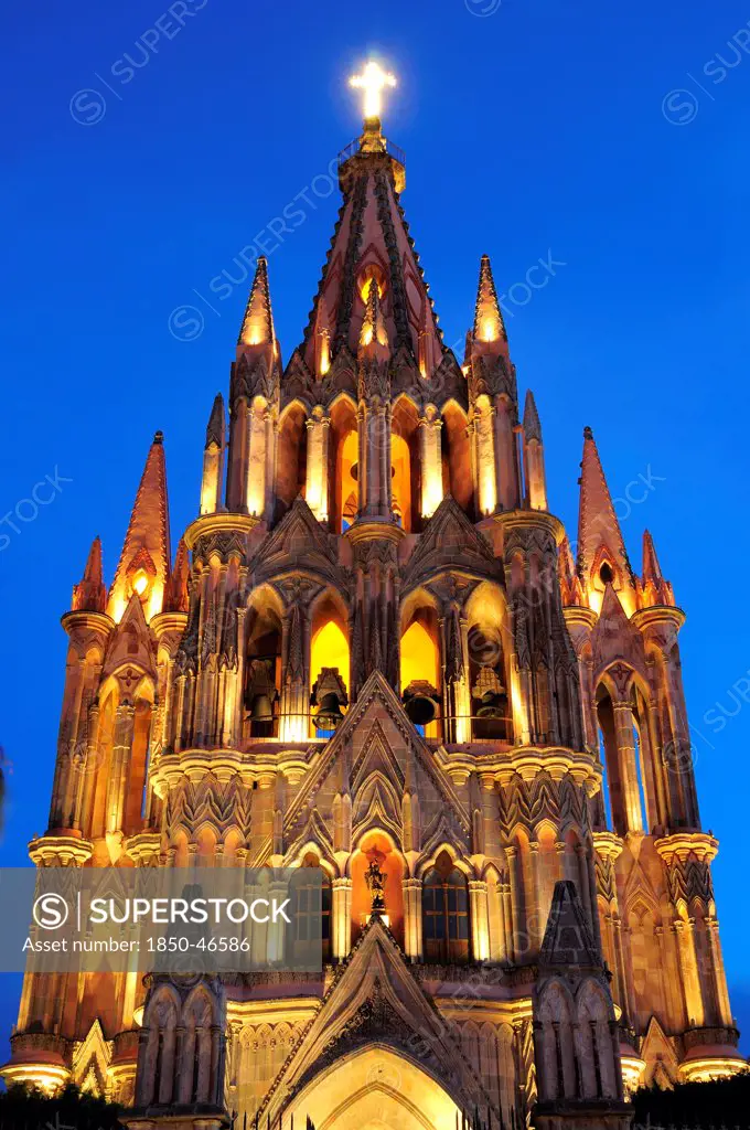 Mexico, Bajio, San Miguel de Allende, La Parroquia church neo-gothic exterior illuminated at night.