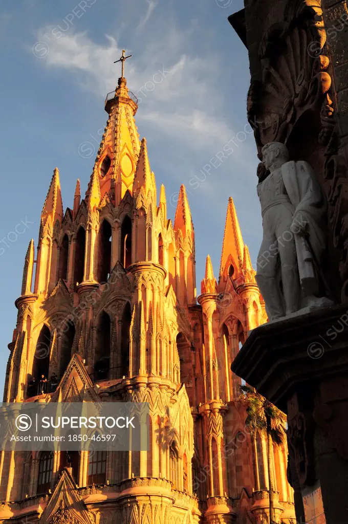 Mexico, Bajio, San Miguel de Allende, La Parroquia de San Miguel Arcangel neo-gothic exterior with statue of Ignacio Allende in foreground.