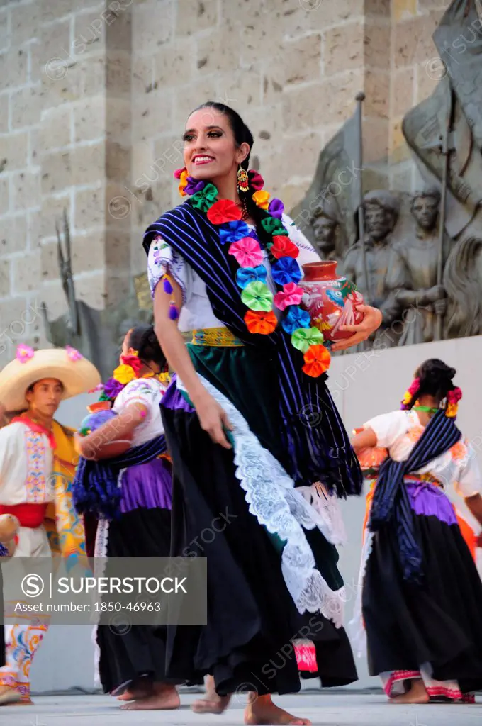 Mexico, Jalisco, Guadalajara, Plaza Tapatia Woman folk dancer from Guerrero State performing in Carnival.