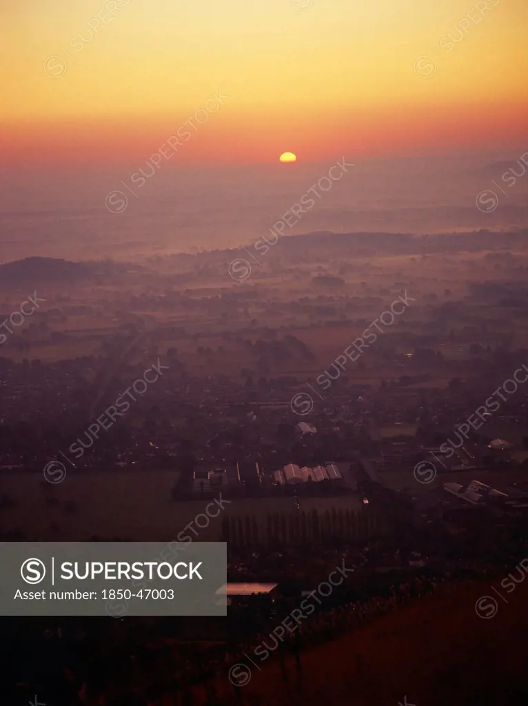 England, Worcestershire, Great Malvern, Sunrise over Great Malvern from Worcester Beacon.