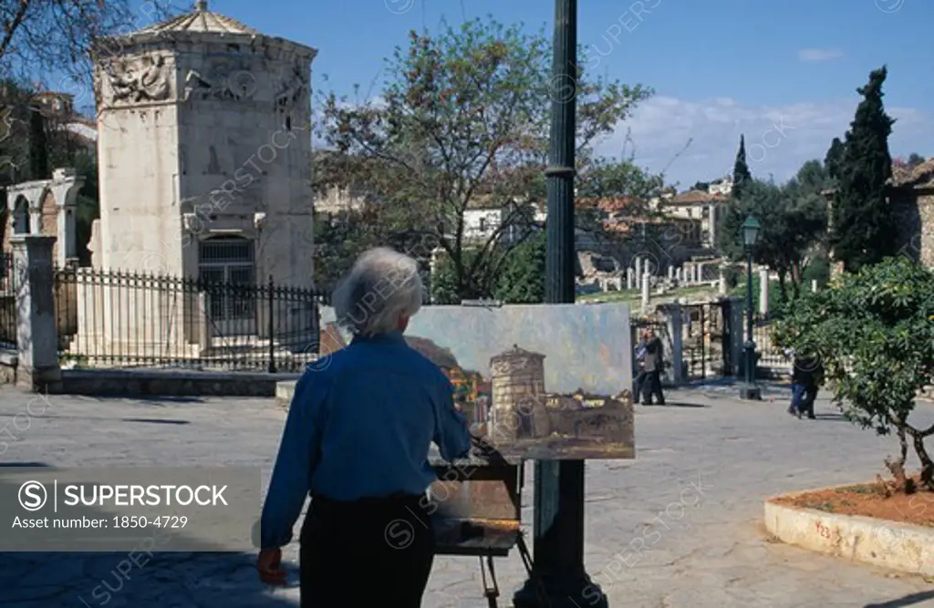 Greece,  , Athens, Temple Of The Winds With Artist Standing At Easel Painting In The Square