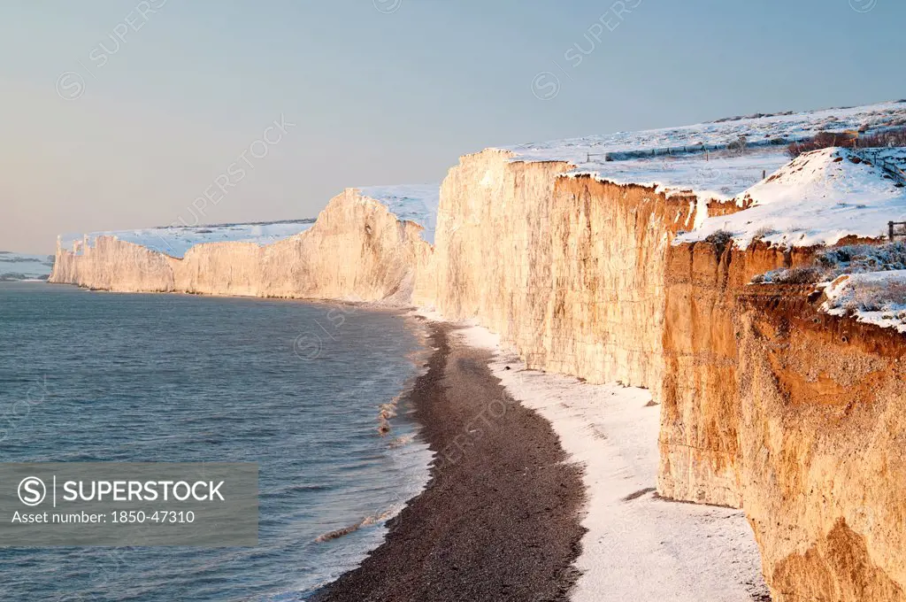 England, East Sussex, Seven Sisters, Snow covered chalk cliffs looking west towards Cuckmere haven from Birling Gap.