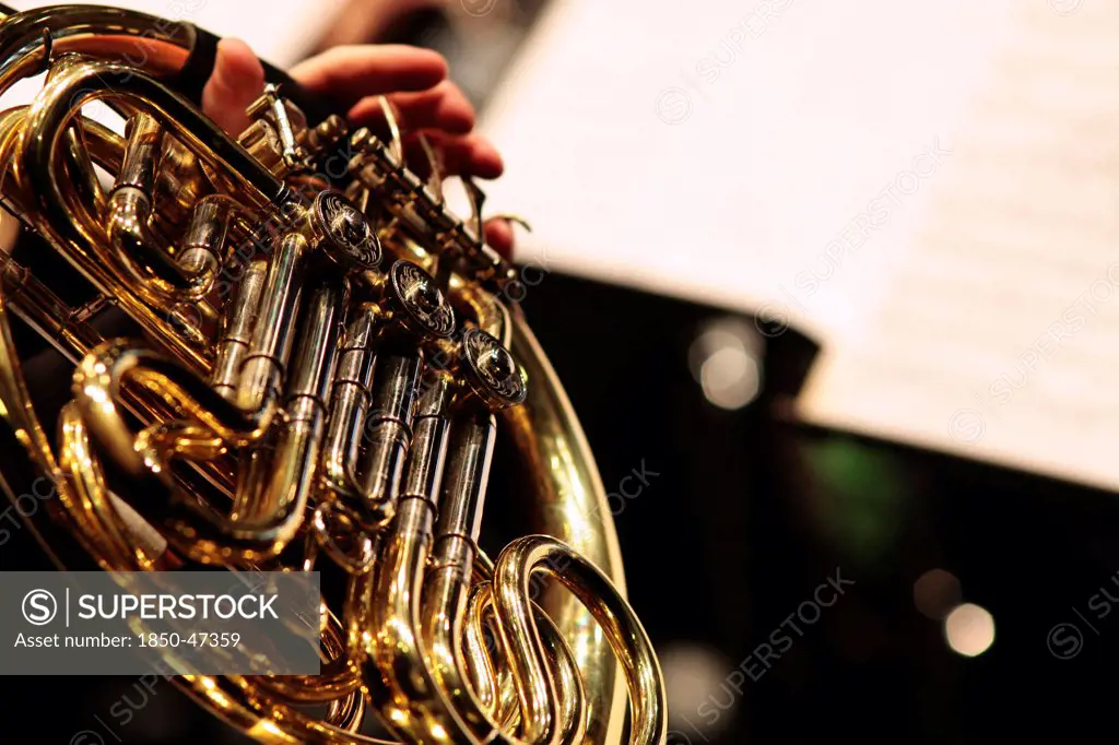 Music, Instruments, Brass, Detail of hand playing notes on a French Horn.