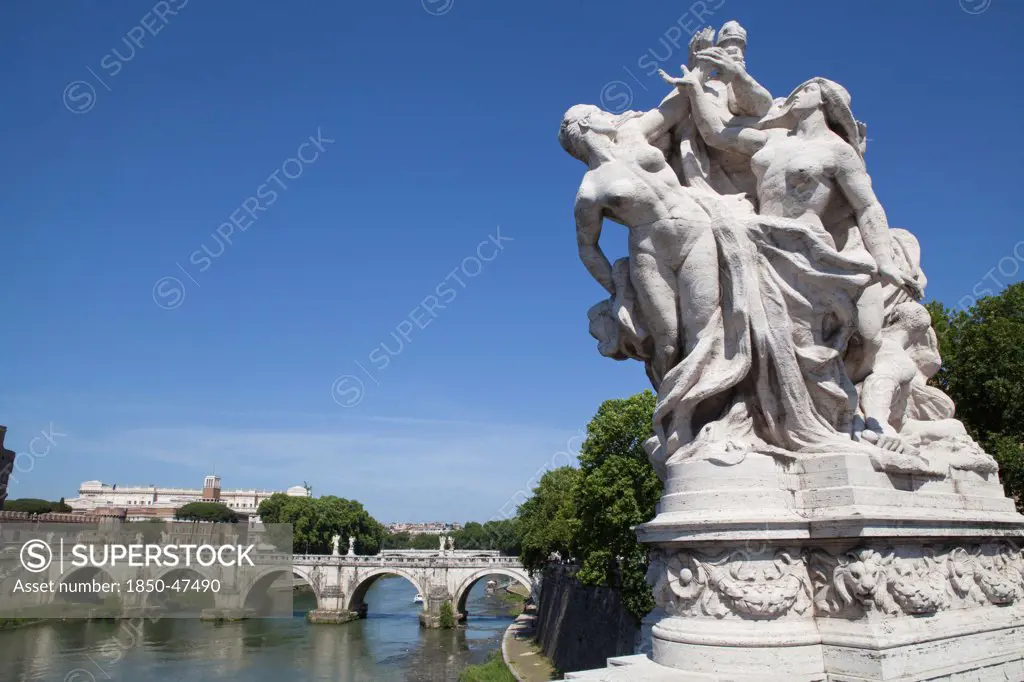 Italy, Lazio, Rome, Statue on the Ponte Vittorio Emanuele with Castel Sant Angelo in the background.