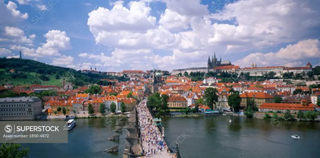 Czech Republic, Stredocesky, Prague, Charles Bridge. View Over Busy Bridge And City Rooftops Beyond.