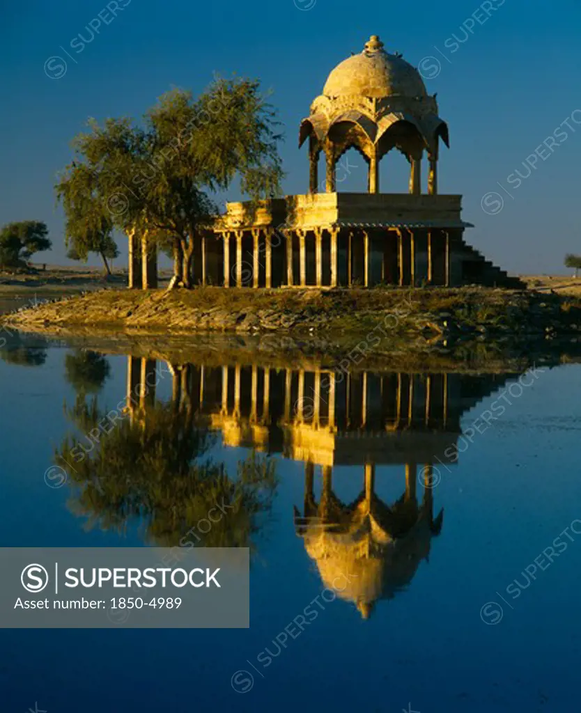 India, Rajasthan, Jaisalmer, Gadi Sagar Tank.  Building Reflected In Water.