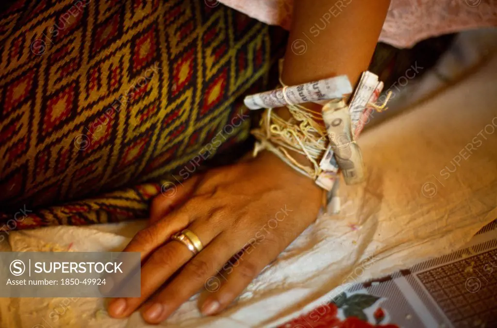 Cambodia, General, Buddhist wedding ceremony. Money attached to wrist.