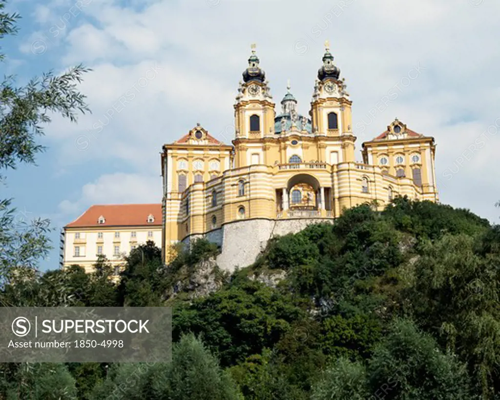 Austria, Lowe Austria, Melk, Melk Abbey With Twin Clocktowers On A Hilltop Surrounded By Trees