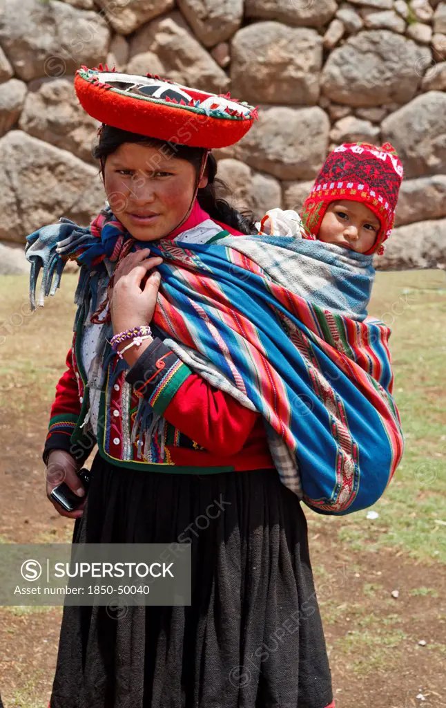 Peru, Indigenous People, Woman with baby in traditional dress.