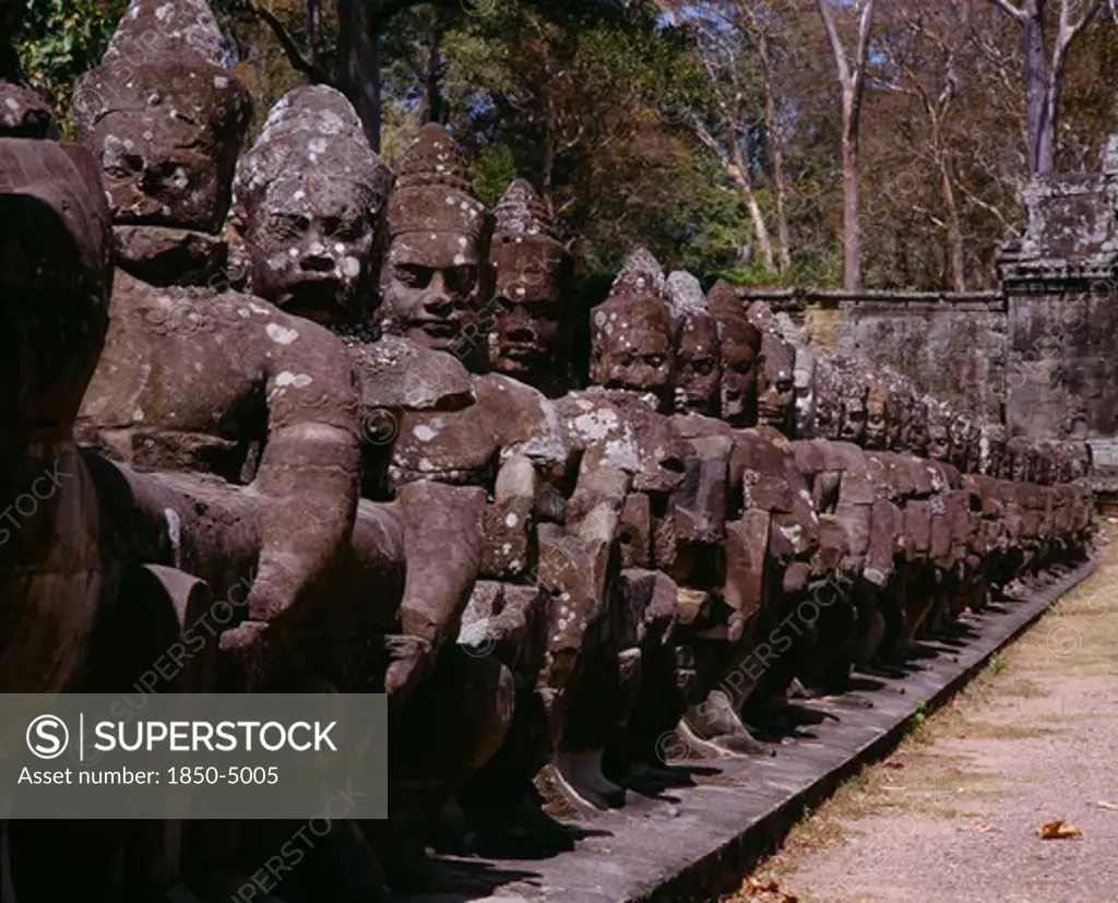 Cambodia, Angkor, Angkor Thom.  Close Up Of Ancient Stone Figures Lining Causeway Leading To Gateways Or Gopuras.