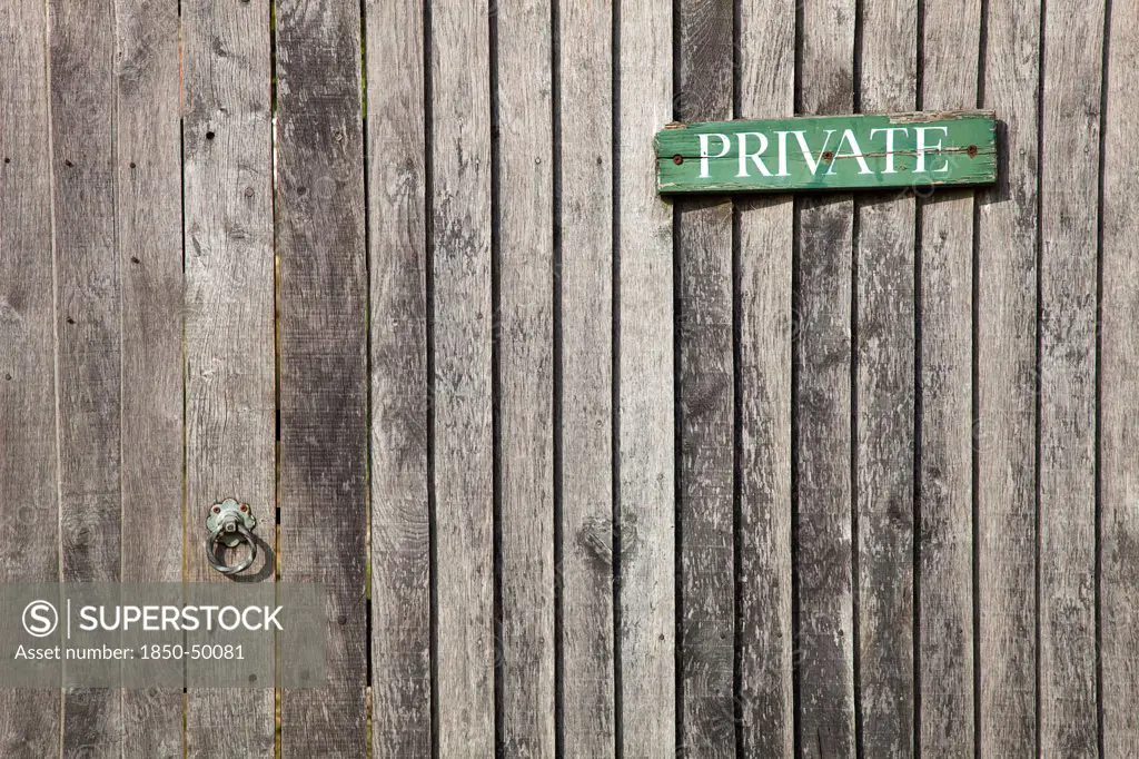 England, West Sussex, Chichester, Architecture Doors Detail of wooden gate and fence with priavte sign.