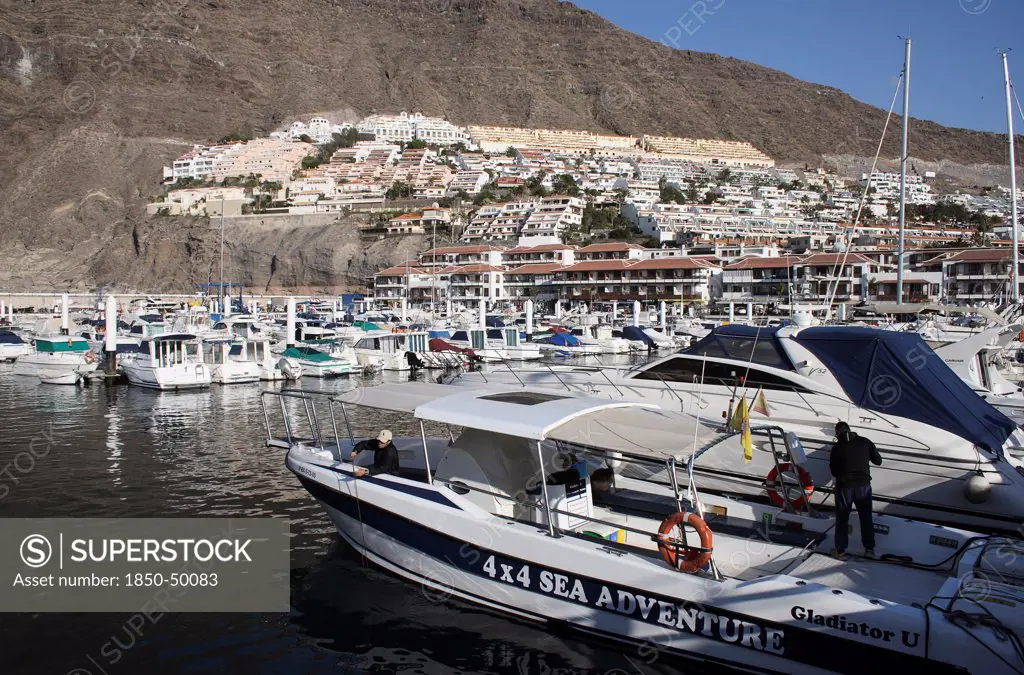 Spain, Canary Islands, Tenerife, Los Gigantes view across marina with boats moored.