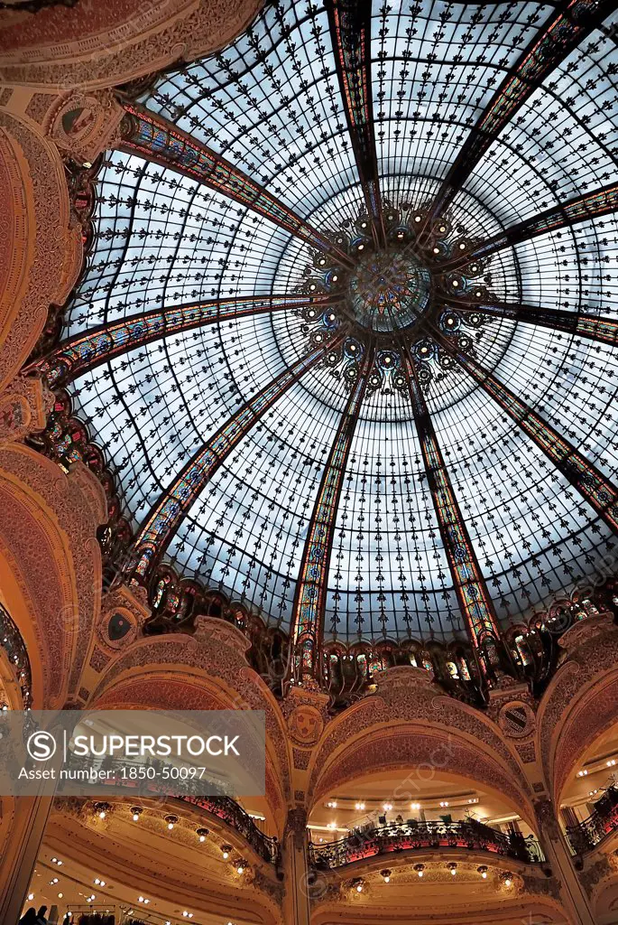 France, Ile de France, Paris, Interior of the Galleries Lafayette store showing the glass domed roof.