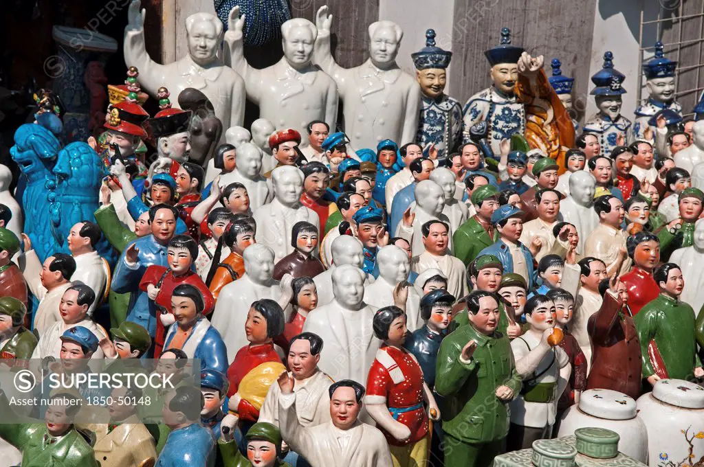 China, Shanghai, Porcelain figurines mainly of Chairman Mao Zedong but also of other Chinese communist leaders and Emperors and courtiers Memorabilia on sale at Dongtai antique market.