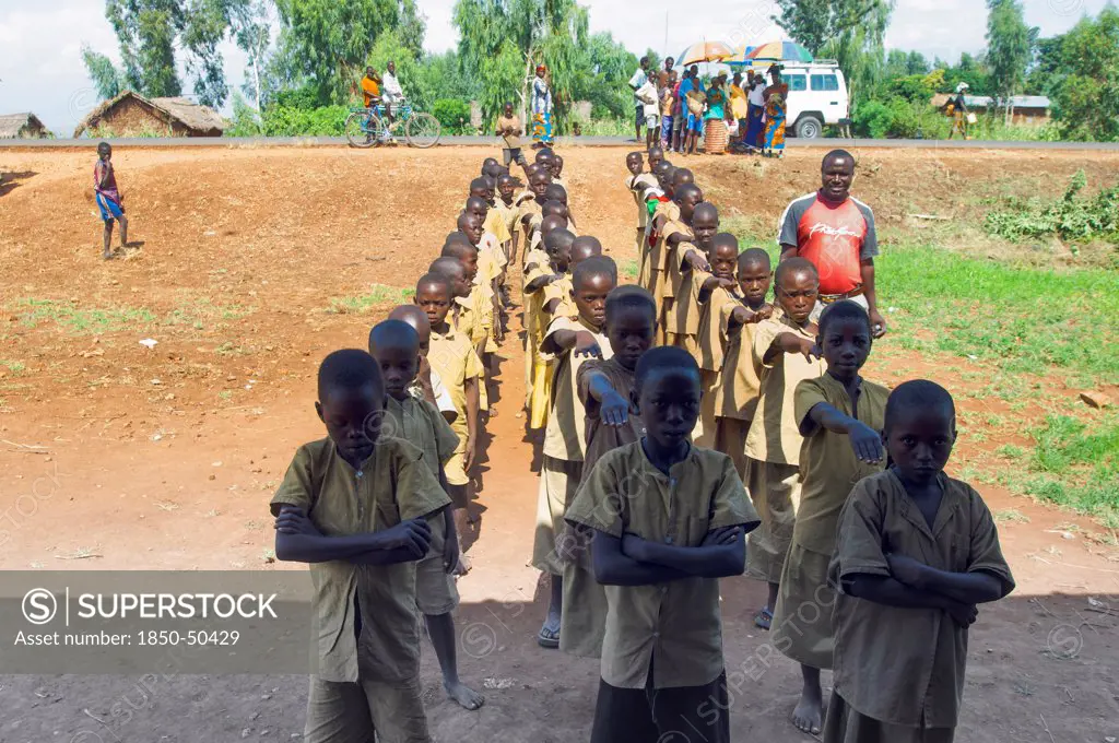 Burundi, Cibitoke Province, Buganda, Ruhagurika Primary Students lining up ready to go into their Catch-Up Class. Catch up classes were established by Concern Worldwide across a number of schools in Cibitoke to provide a second chance for children who had previously dropped out of school.