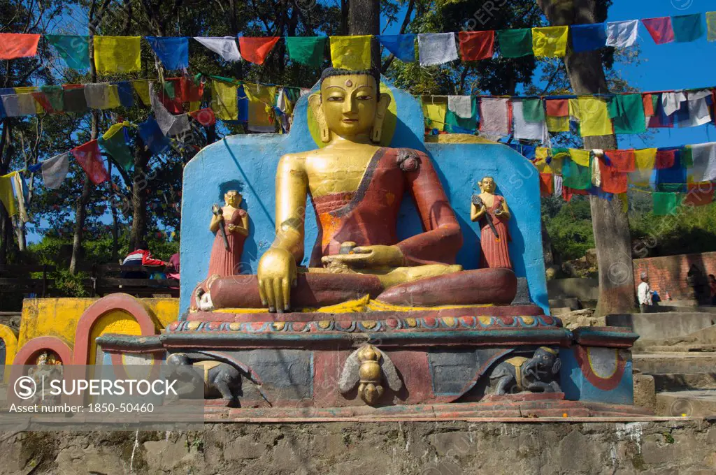 Nepal, Kathmandu, Buddha statue at the foot of the Swayambunath Monkey Temple.