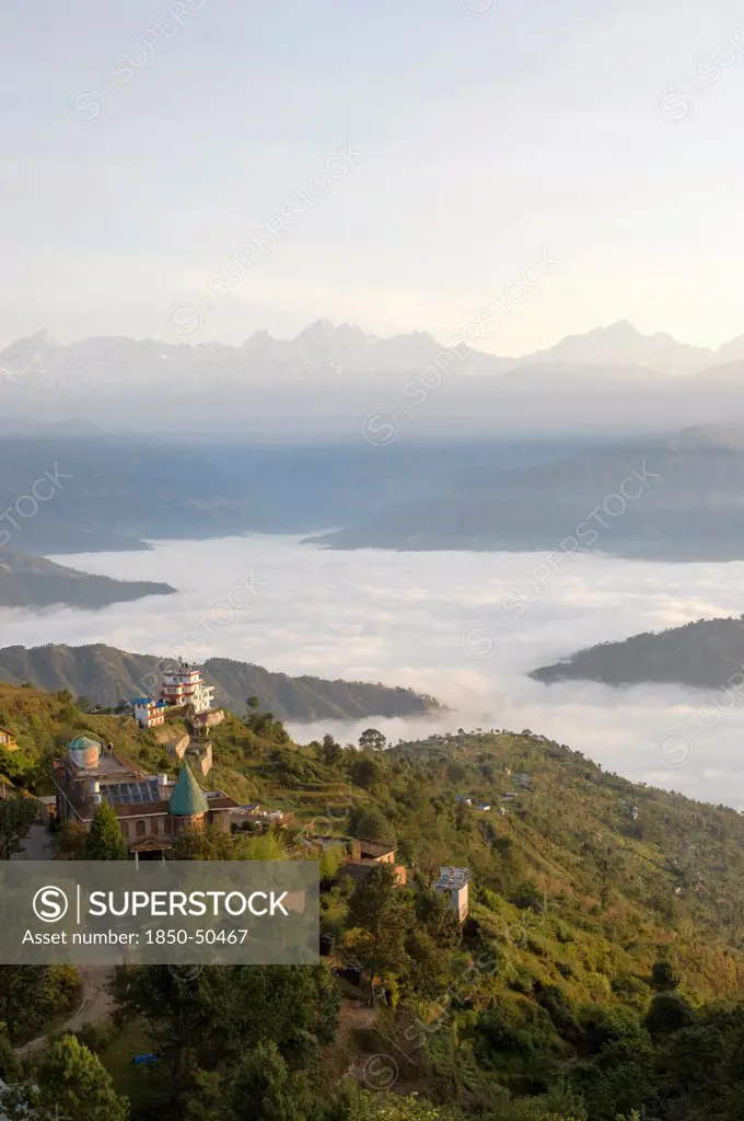 Nepal, Nagarkot, View across clouded valley towards Himalayan mountains.