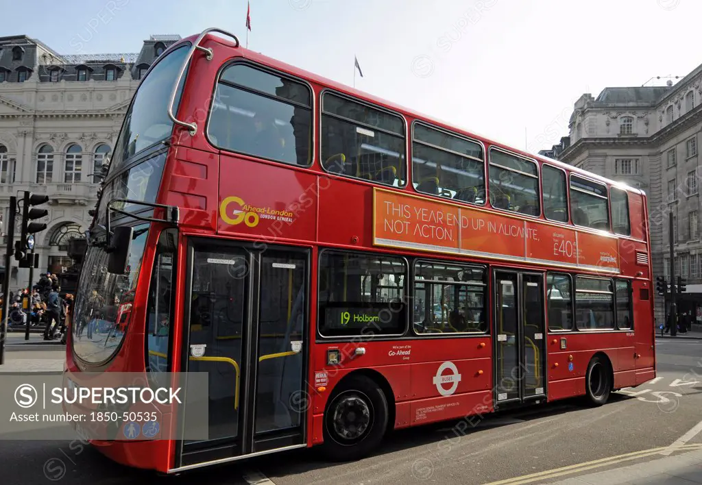 England, London, Red bus travelling through Piccadilly Circus.