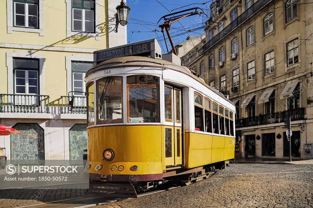 Portugal, Estremadura, Lisbon, Praco do Fiqueira yellow tram number 28 entering the square.